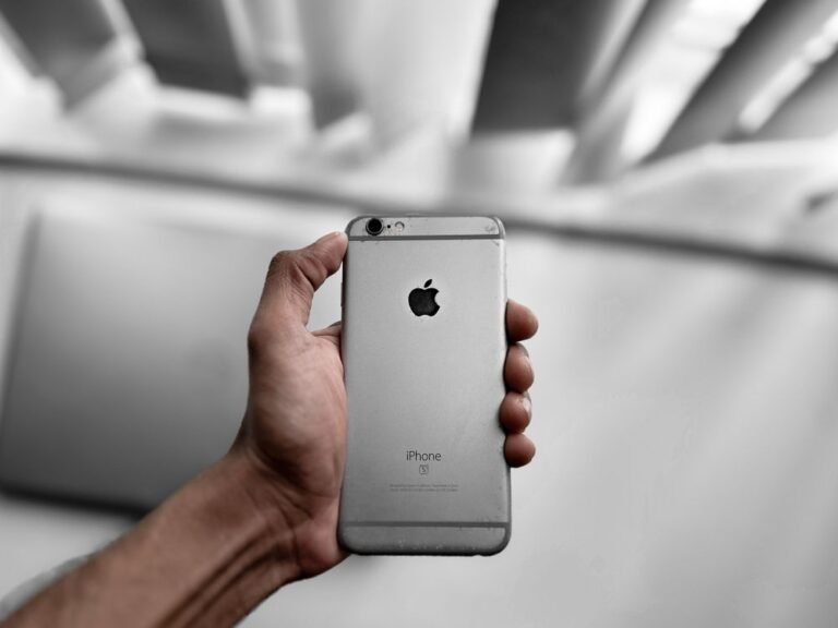 Hand holding a smartphone, a phone keeps restarting fix