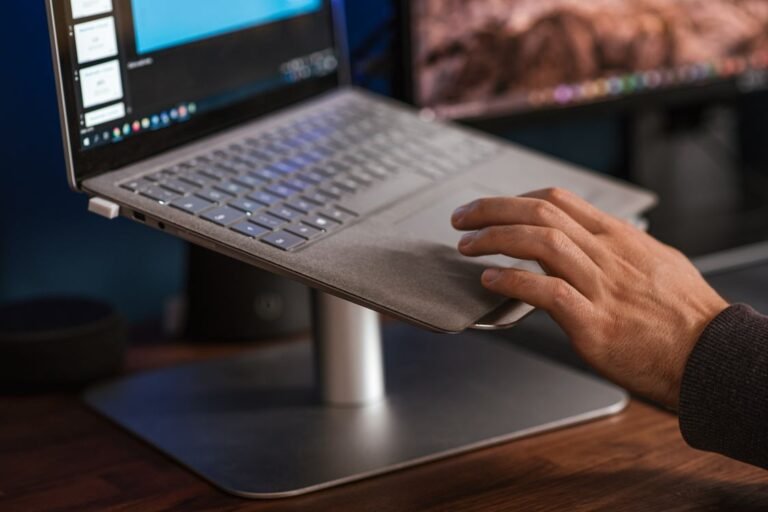 Laptop raised on a metal stand on a desk with air flowing underneath, a loud laptop fan fix