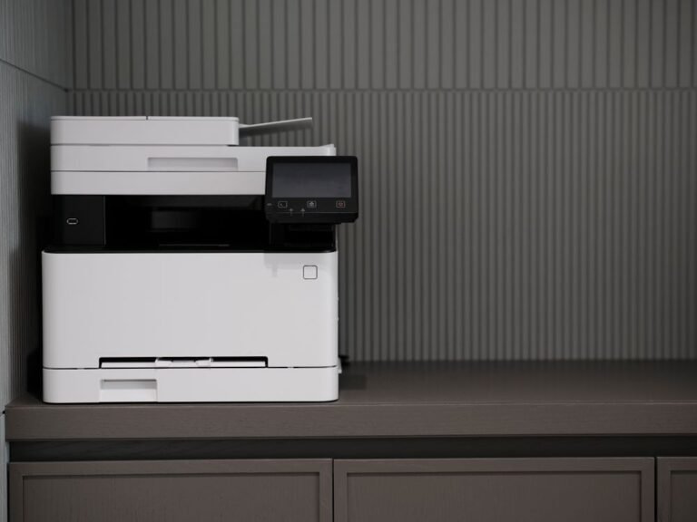 Modern printer with a touchscreen sitting on an office desk, a printer not printing fix.